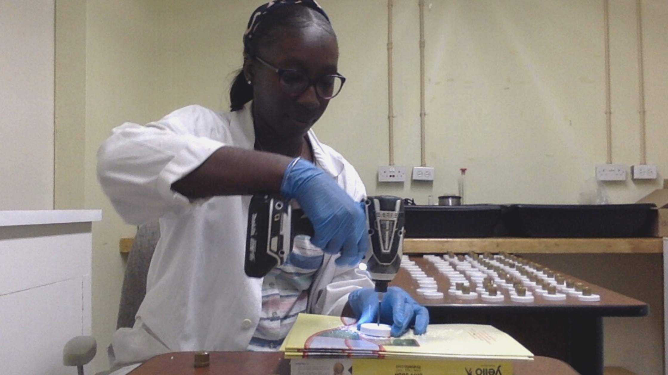 Shamika Spencer, research student with Rum and Sargassum biofuels working in the lab